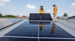 expert solar installer holding solar panel- Big Texan Solar