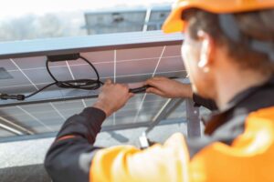 electrician connecting solar panels- Big Texan Solar