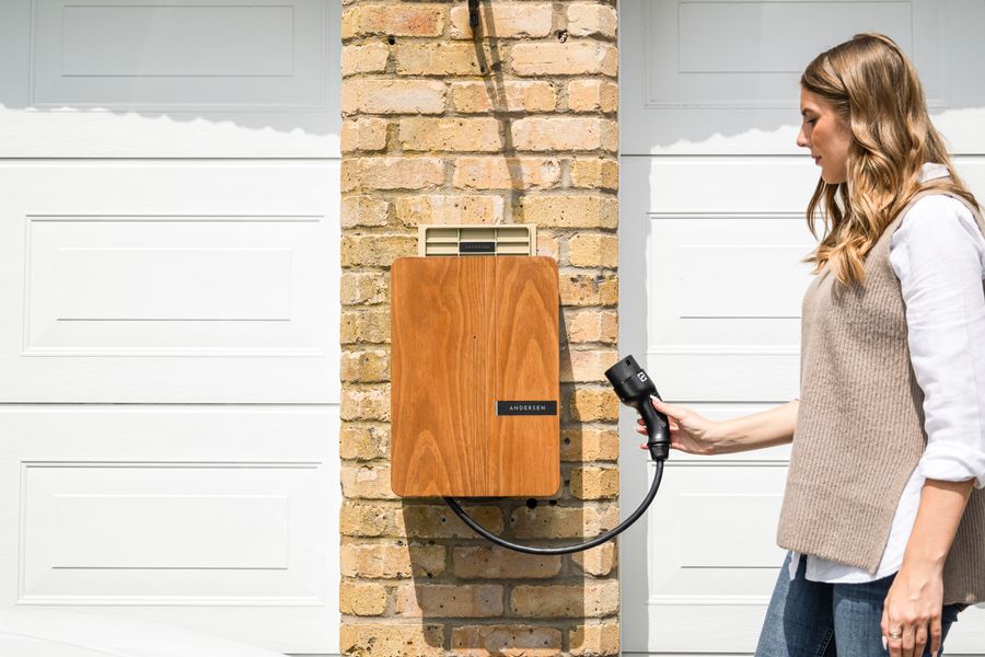 home EV charger mounted on a garage wall powered by solar