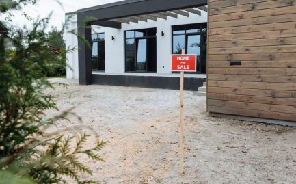 Texas home with solar panels listed for sale with a yard sign