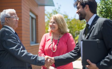 Texas homeowners shaking hands with a solar provider over a lease agreement