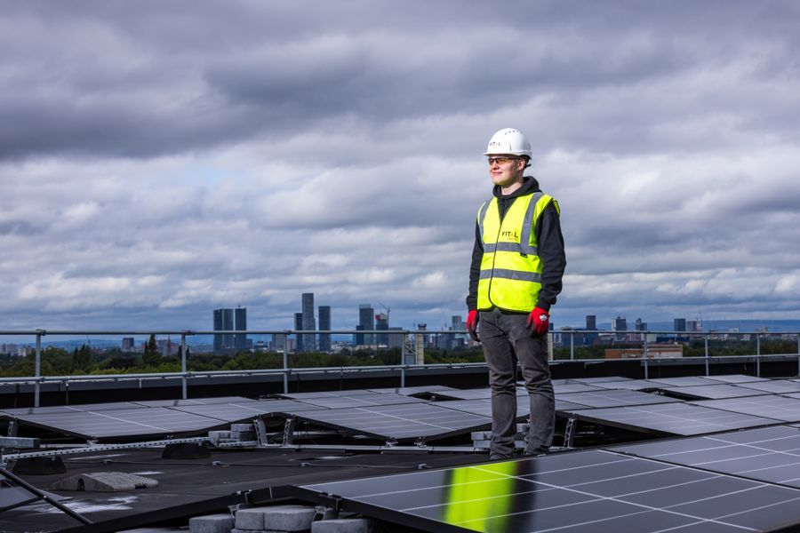 solar installer inspecting rooftop panels under a cloudy Texas sky