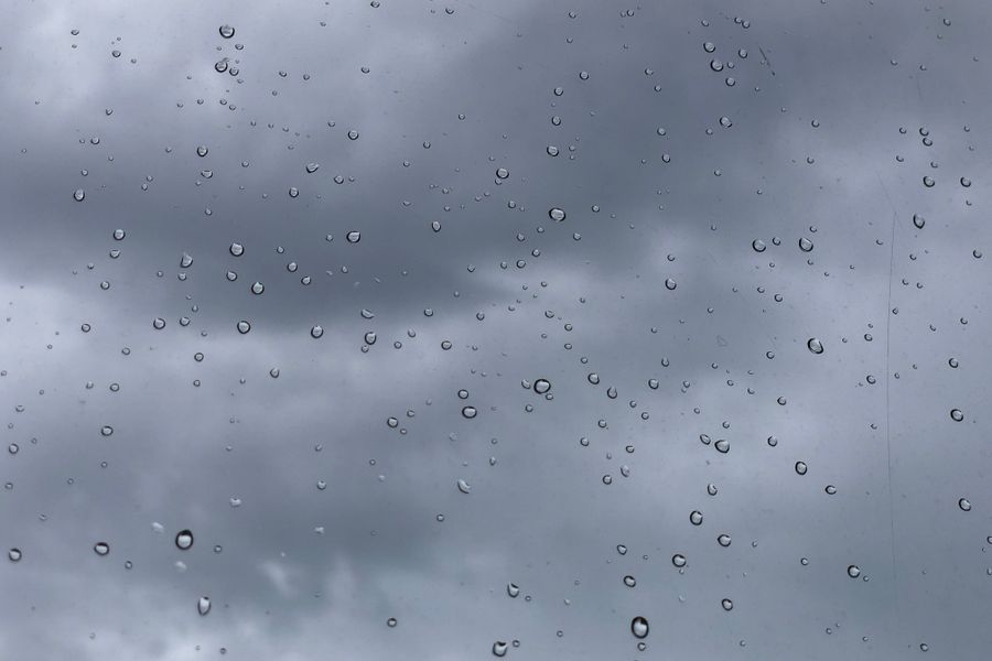 rain on a window with storm clouds over a Texas neighborhood
