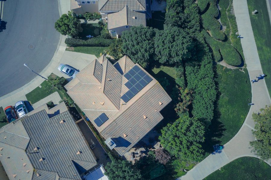 Texas neighborhood homes with rooftop solar panels after a storm